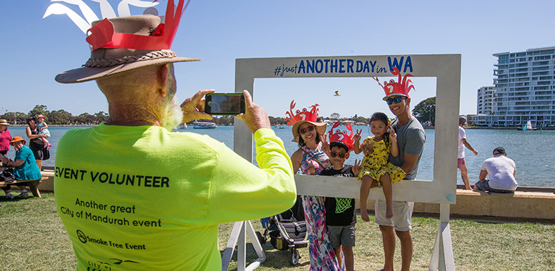 A volunteer at Crab Fest 2019 taking picture of family